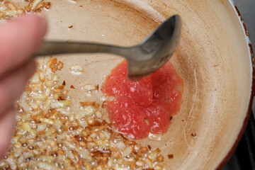 Cooking a flavorful sauce with sautéed onions and fresh tomatoes