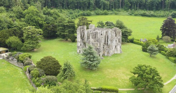 View of ancient Wardour Castle in bright woodland setting, UK heritage site