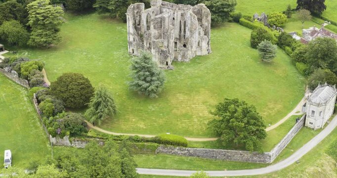 Aerial view of old Wardour Castle, surrounded by gardens and woods, heritage tourism
