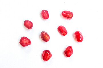 red pomegranate seeds isolated on white background