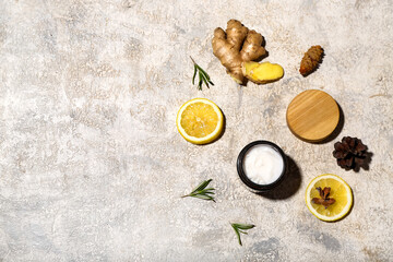 Composition with jar of cosmetic product and natural ingredients on grunge background