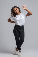 A woman is standing with her arms crossed and waving