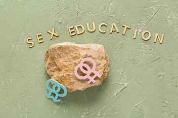 Stone, female and male symbols with text SEX EDUCATION on grey grunge background