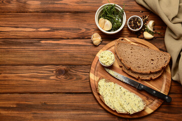 Board of bread slices with fresh butter and different spices on wooden background