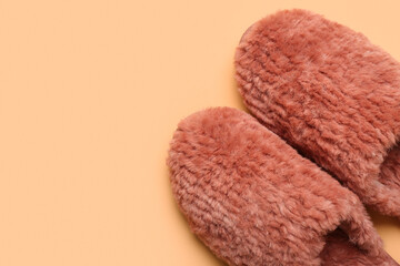 Pair of red soft slippers on beige background. Top view