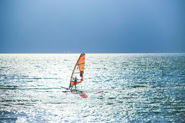 windsurfing on the lake at sunset. Italy. 23.09.2018