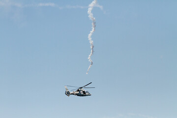 Military copter tries to avoid being hit by a missile during war operational. А rocket has been...
