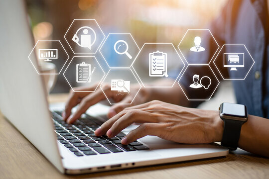 Person using laptop with digital interface showing business process management icons