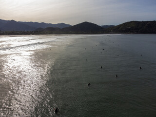 hundreds of surfers waiting for a perfect wave