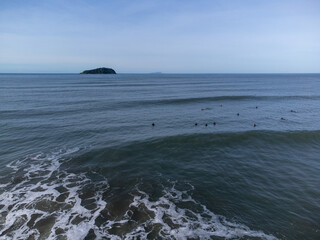 hundreds of surfers waiting for a perfect wave