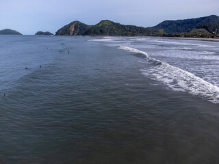 hundreds of surfers waiting for a perfect wave