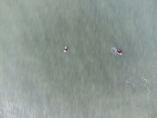 hundreds of surfers waiting for a perfect wave
