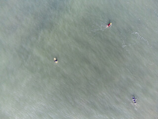 hundreds of surfers waiting for a perfect wave