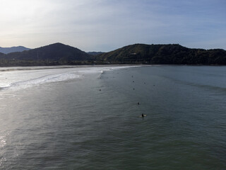 hundreds of surfers waiting for a perfect wave
