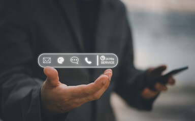 24-7 customer service support concept. Businessman hands holding digital contact icons, including email, phone, and chat, representing communication, accessibility, and online business care.
