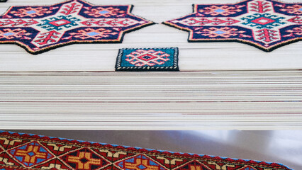 Manufacturing process, weaving of a traditional wool oriental red carpet with an intricate floral...