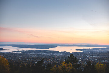 Sunset from Vettakolltoppen paints Oslofjord in soft pastels, offering a serene panorama above the city—an unforgettable moment of Norwegian autumn tranquility