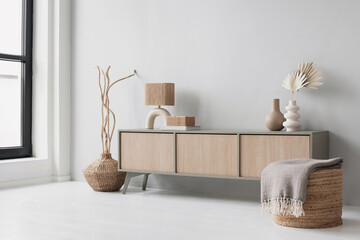 Modern scandinavian style interior with chair, commode and trendy lamp. Elegant living room decor. Home staging and minimal interior design concept. Empty wall copy space. © kite_rin