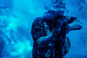 Soldier in camouflage outfit with rifle and tactical gear aiming amidst blue smoke in a dynamic, intense scene.