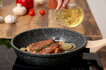 Frying of tasty steak in kitchen