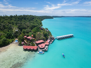 Maratua, Indonesia: Aerial view of a seafront resort with overwater bungalows in the Maratua lagoon...