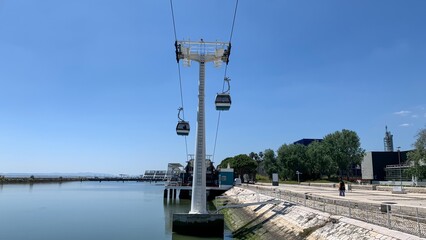 Cable cars glide gracefully over the serene river, evoking Portugal's Liberation Day spirit and...