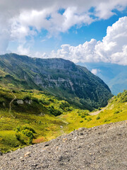 Mountain road leading through the Path of Health hiking trail at Rosa Khutor resort in Sochi,...
