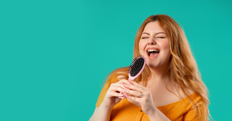 Body positive woman Singing, Dancing With Hair Brush Instead Microphone On Blue