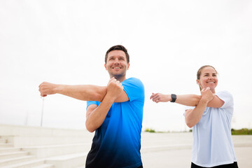 Stretching and Warming up Together Outdoors Enhances Focus and Motivation for Fitness Enthusiasts...