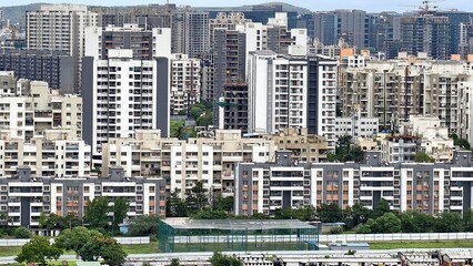 High-rise residential buildings in a densely populated Indian cityscape, showcasing modern urban living, construction growth, and architectural development. 