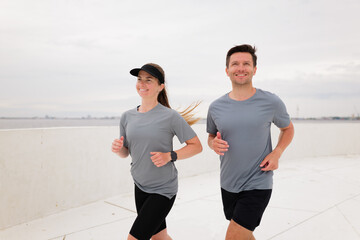 Morning Joggers Enjoying a Refreshing Run Along the Waterfront Promenade in a Coastal City Under an...