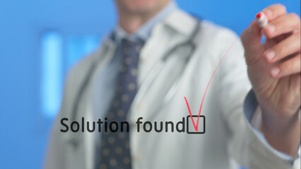 Doctor writing solutions and marking checkboxes on a transparent screen, representing innovative...