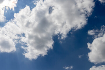 beautiful blue sky with lush white clouds in sunny bright weather