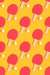 Repetitive pattern made of tennis racket and white ball on a yellow background. Creative ping pong layout.