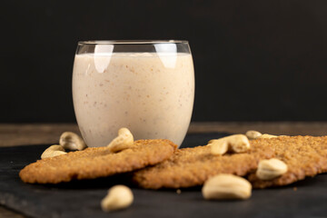 cookies and a glass of yogurt with prunes, a light breakfast of oatmeal cookies and a glass of yogurt