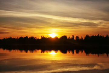 Warm summer sunrise-sunset over the northern river, calm water (breathless), but colors of an alarming sunset
