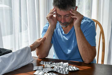 Doctor comforts and supports a man with prescription Drug addiction, painkiller dependency, Opioid...
