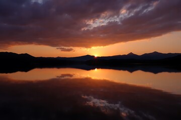 Obraz premium Beautiful sunset over lake with mountain range reflection landscape scenic view nature photography