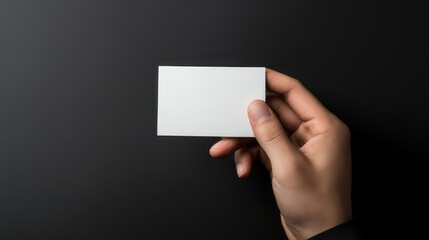 Minimalist business card with modern typography placed on sleek black textured background for corporate branding and professional identity design concepts




