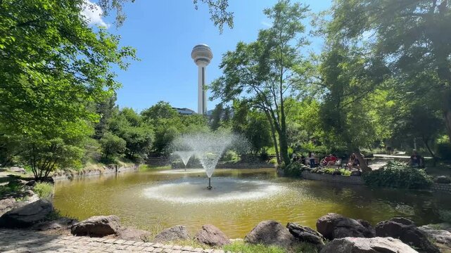 Ankara, Turkey - June 15, 2025: Botanical Garden and Atakule in background in the spring, 