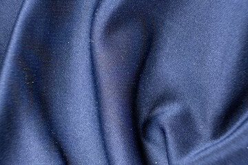 Low-quality synthetic fabric with signs of wear on the surface.