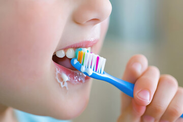 Small child learns to brush their teeth, hygiene and a healthy lifestyle from an early age