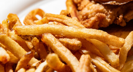 Close up of a fried chicken sandwich and fries with a shallow depth of field and copy space