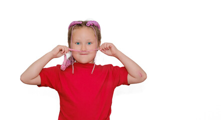 Child wearing red shirt humorously uses braided hair as a mustache, creating a playful and fun moment. The child displays a cheerful expression against a plain white background.