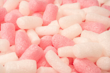 Pink and white box filler as a background. Top view.