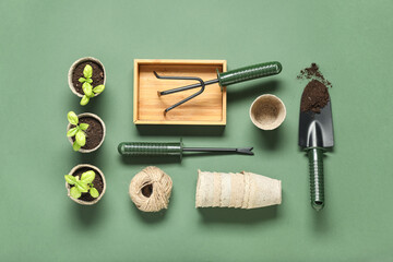 Composition with potted plants and different gardening supplies on green background