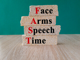 The acronym FAST on brick blocks. FAST stands for 'facial drooping', 'arm weakness', 'speech...