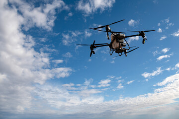 Agricultural drone spreading fertilizer on a newly planted field in Argentina. Smart farm. Unmanned aerial vehicle (UAV).