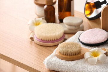Set of spa accessories, flowers and cosmetic products on wooden table