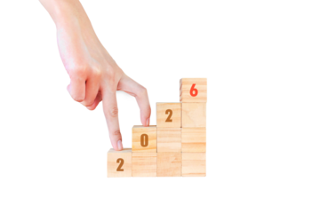 Transition years 2025 to 2026 on wooden blocks with copy space. To prepare for the new year changes and start thinking about strategies and new business goals. PNG